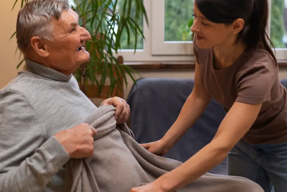 elderly person being taken care by female carer